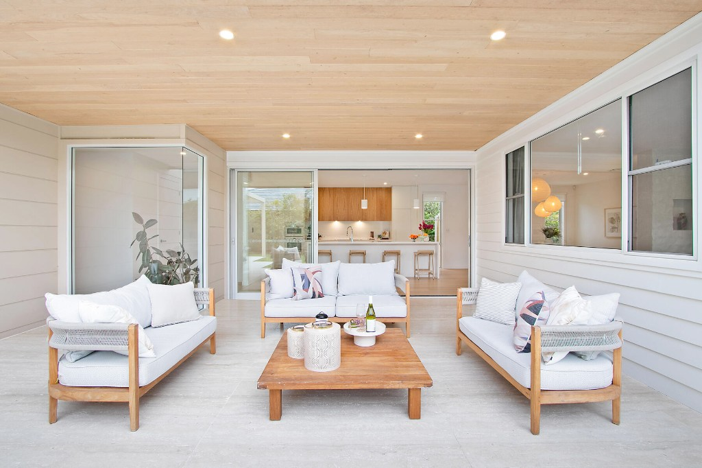 Outdoor lounge opening to a modern kitchen
